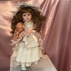 Charming Porcelain Doll in Peach and Cream Dress